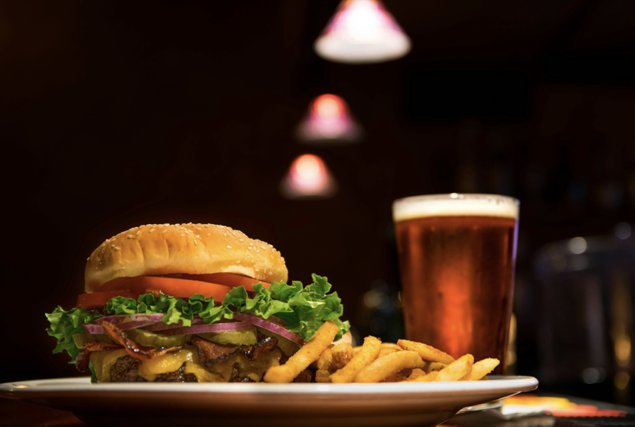 Image of pub food with pint of beer, burger and fries.